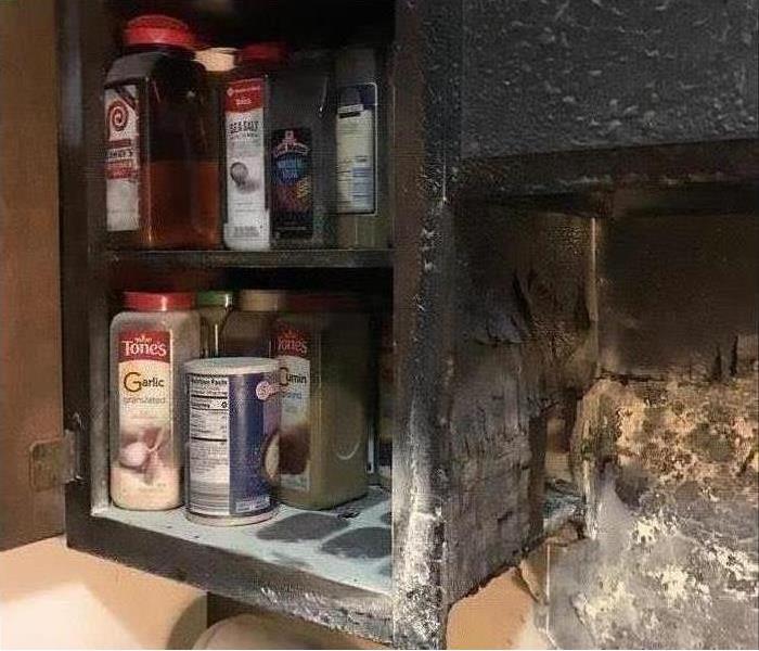 burned kitchen cabinet, spices and condiments
