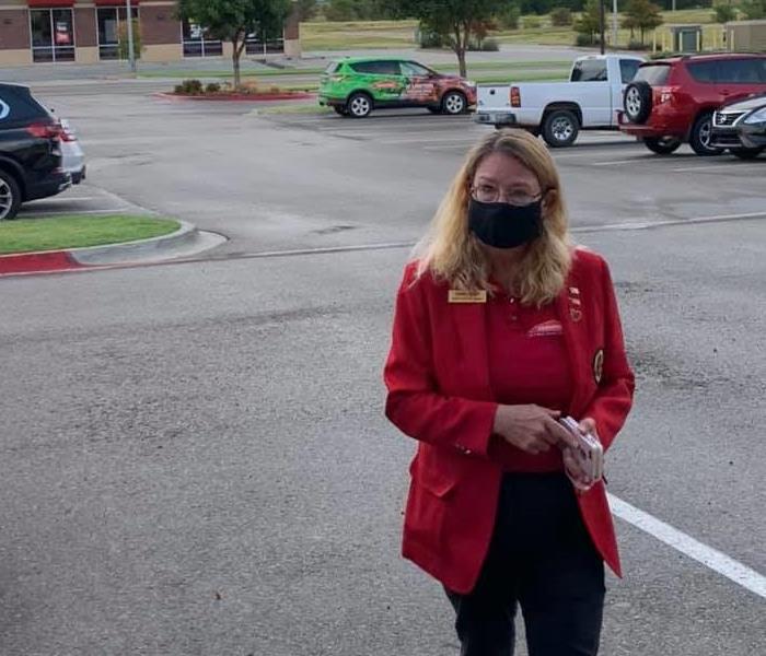 Woman in red coat in parking lot