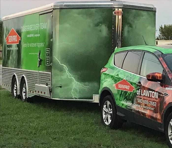 green trailer, orange and green car