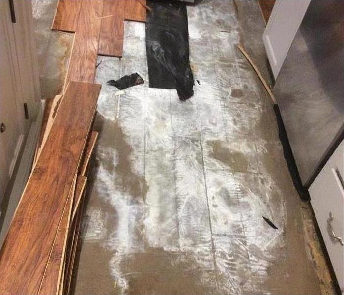water damaged flooring in a kitchen