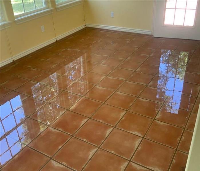 red tile floor covered in water