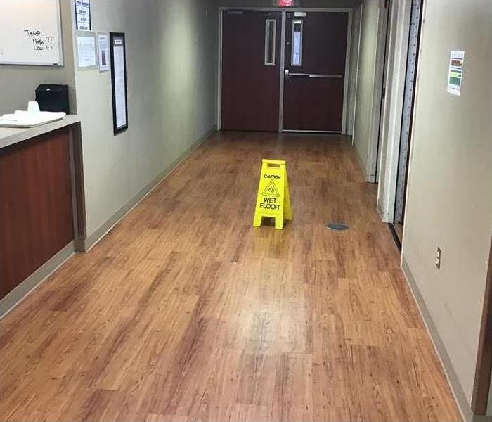 hospital hallway, wet floor signs